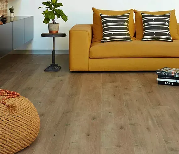 Brightly coloured couch on timber flooring